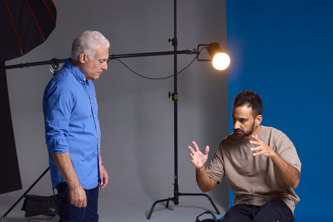 Luis Cano providing professional creative direction and posing guidance to models on a high-end commercial fashion set.