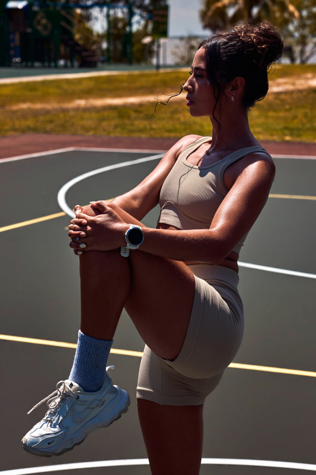 Commercial fashion and fitness visual campaign titled The Divine Dualism. High-end editorial production exploring feminine duality through high-contrast storytelling: combining styled luxury glamour with raw, athletic movement. Shot on location in Miami using hybrid natural light and flash techniques, directed by Luis Cano. Dynamic action sports photography of a model running in Miami for a luxury sportswear campaign, captured by Luis Cano.