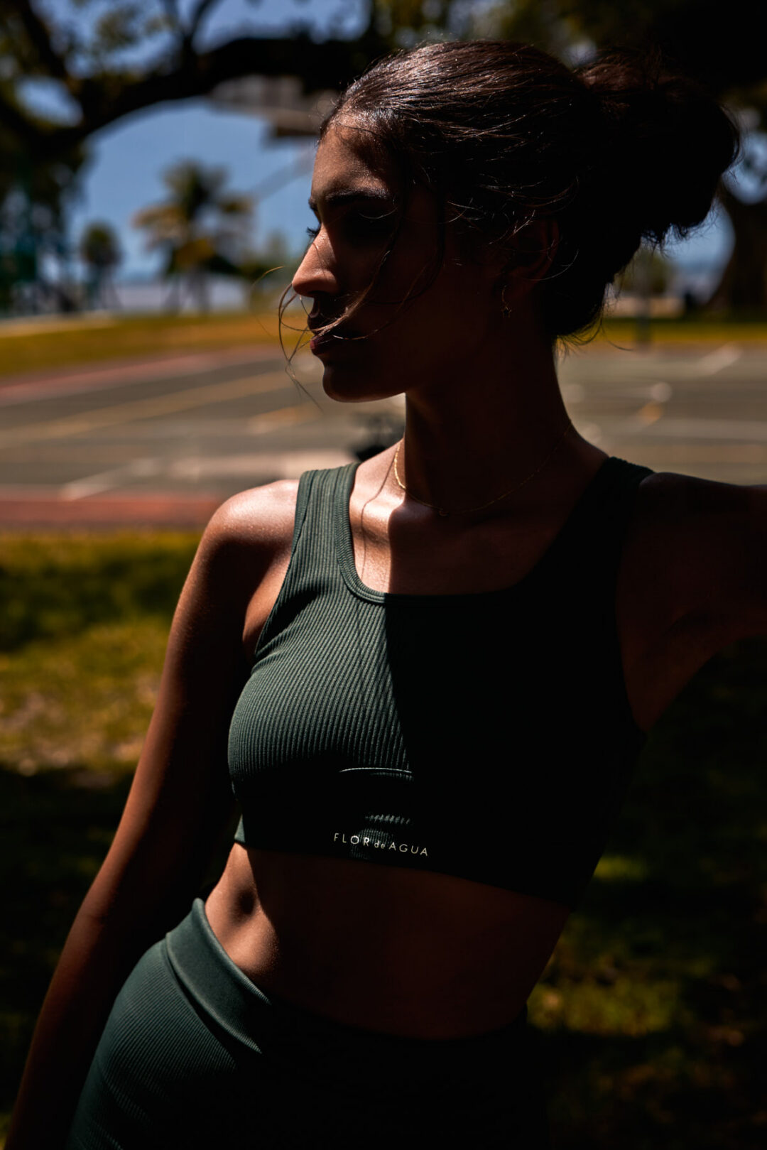 Commercial fashion and fitness visual campaign titled The Divine Dualism. High-end editorial production exploring feminine duality through high-contrast storytelling: combining styled luxury glamour with raw, athletic movement. Shot on location in Miami using hybrid natural light and flash techniques, directed by Luis Cano. Dynamic action sports photography of a model running in Miami for a luxury sportswear campaign, captured by Luis Cano.